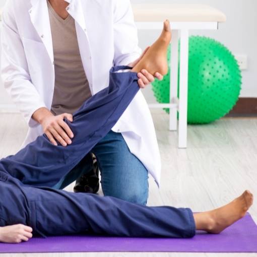 Chiropractor holding patient's leg