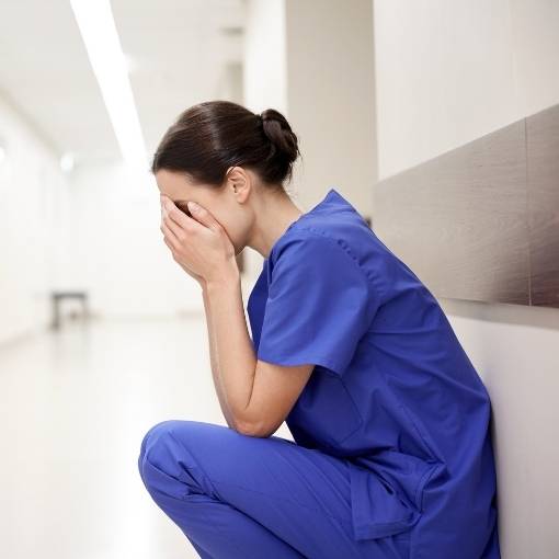 Medical Worker Crying in Corner